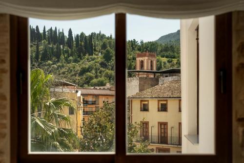 a view of a city from a window at Casa Cresolera in Villalonga