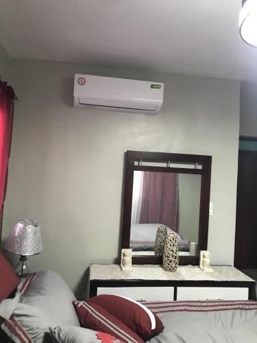 a bedroom with a air conditioner and a mirror at Residencial Santa Rosa Apto 8 Section C in Moca