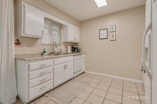 a kitchen with white cabinets and a sink at A WAVE FROM IT ALL - Pet & Family Friendly Home with Beautiful Views! in Lake Havasu City
