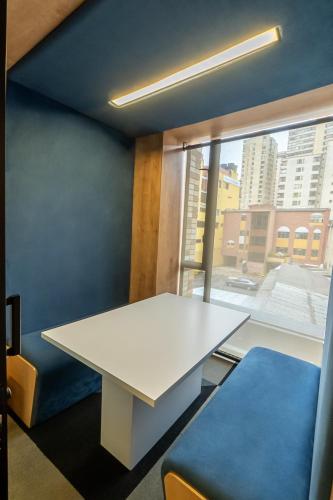 a white table in a room with a window at CentralX 21 Bogotá in Bogotá