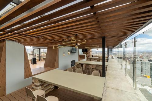 a dining area with a table and chairs in a building at CentralX 21 Bogotá in Bogotá