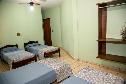 a room with two beds and a window at RP HOTEL in Ribeirão Preto