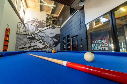 a billiard table with a bat and a ball at CentralX 21 Bogotá in Bogotá