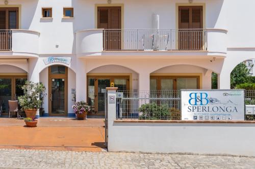 a building with a sign in front of it at B&B Sperlonga in Sperlonga