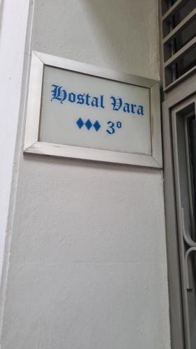 a street sign on the side of a building at Hostal Vara Madrid in Madrid