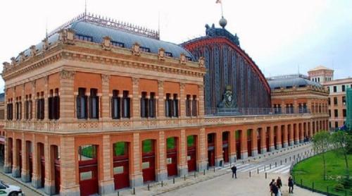 a large brick building with people walking in front of it at Hostal Vara Madrid in Madrid
