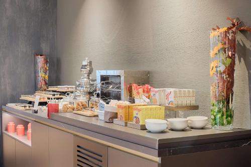 a counter with bowls and other items on it at NH Collection Murano Villa in Murano