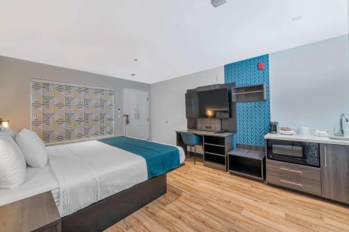 a hotel room with a bed and a kitchen at Studio 6 Suites Stockton, CA Waterfront in Stockton
