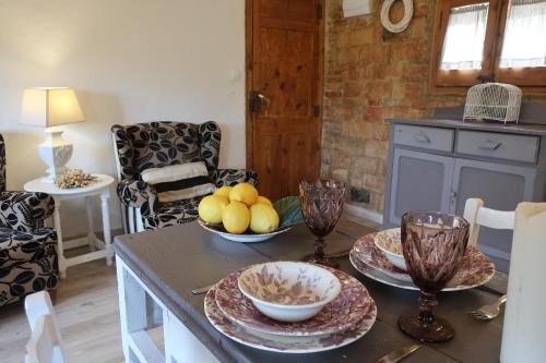a kitchen with a table with bowls of fruit on it at Masia Sagués in Poblet