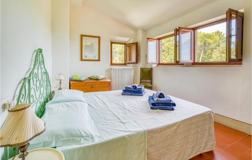 a bedroom with a large bed with blue towels on it at 2 Bedroom Lovely Home In Loro Ciuffenna in Loro Ciuffenna