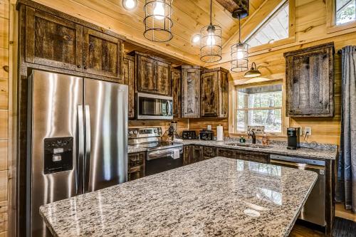 a kitchen with a stainless steel refrigerator and wooden cabinets at Mountain View Retreat in Cherry Log