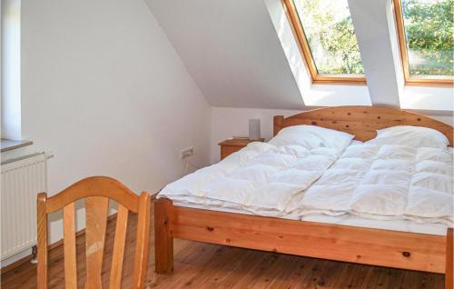 a bedroom with a large bed with a window at Awesome Home In Karwesee With Sauna in Karwesee
