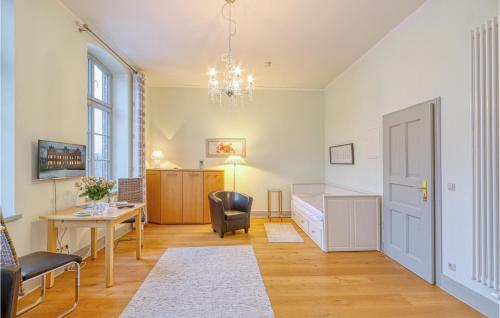 a room with a bedroom and a desk and a bed at Cozy Apartment In Krakow Am See With Kitchenette in Krakow am See