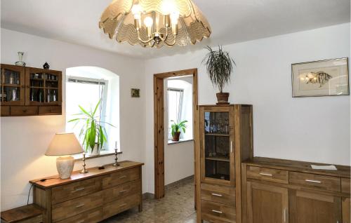 a room with a chandelier and a wooden cabinet at Pet Friendly Apartment In Freiberg in Freiberg