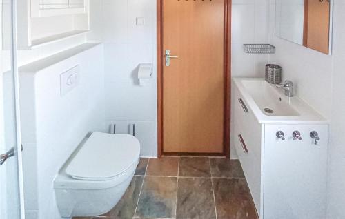 a bathroom with a toilet and a sink at Calimero in Sint Annaland
