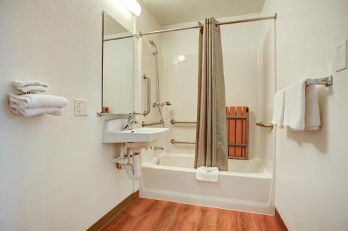a bathroom with a tub and a sink and a shower at Motel 6-Elkton, MD in Elkton