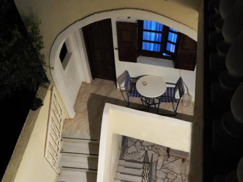 an aerial view of a house with a table and chairs at Evelina Family Beach Pension a breath away from the Black Beach offer plenty of accommodation type to suit every traveler's needs-Economic Rooms-Thematic Rooms-Design Rooms-Kitchenette Rooms-Studios-Small Apartments in Perissa
