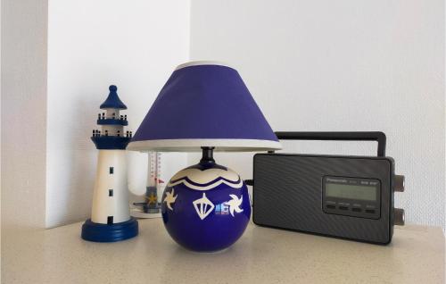 a blue vase with a lamp next to a clock and a lighthouse at 1 Bedroom Amazing Apartment In Oostende in Ostend