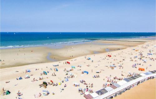 a group of people on a beach near the ocean at 1 Bedroom Amazing Apartment In Oostende in Ostend