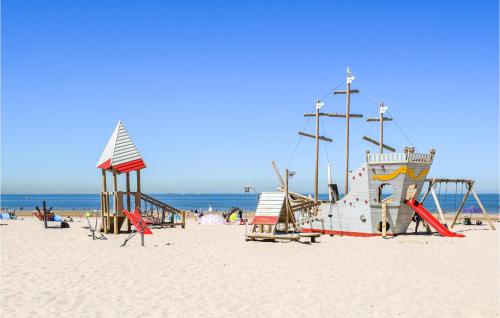 a playground on a beach with the ocean in the background at 1 Bedroom Amazing Apartment In Oostende in Ostend
