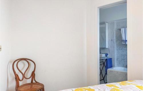 a chair sitting in a room with a bathroom at 1 Bedroom Amazing Apartment In Oostende in Ostend