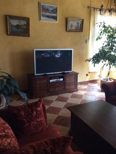 a living room with a flat screen tv at Gnizdo Golubky in Shaian