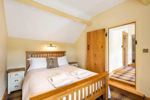 a bedroom with a bed with two towels on it at Pen Y Bont in Llangollen