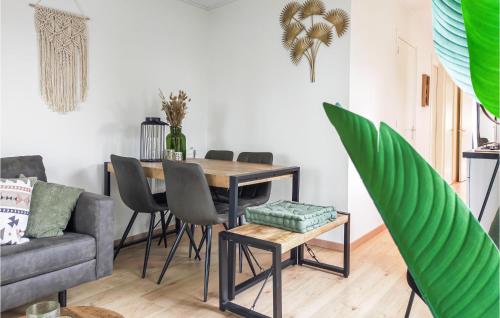 a living room with a table and a couch at Pet Friendly Home In Heinkenszand in Heinkensand