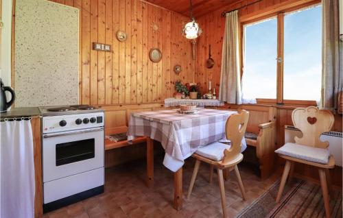 een keuken met een tafel, een fornuis en stoelen bij Lovely Home In Leutasch With Kitchen in Leutasch
