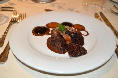 a white plate with a chocolate dessert on a table at Castilia suites in Tozeur