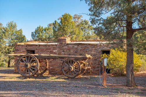 an old brick building with a woodenoked cart in front at Rawnsley Park Station in Flinders Ranges