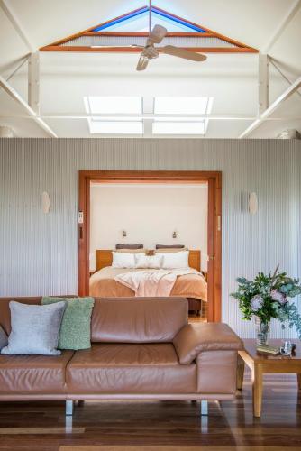 a living room with a couch in front of a bed at Rawnsley Park Station in Flinders Ranges