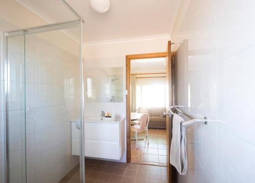 a bathroom with a shower and a tub and a sink at Rawnsley Park Station in Flinders Ranges