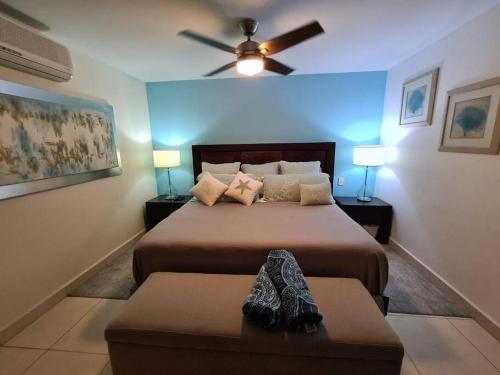 a bedroom with two beds and a ceiling fan at Villamagna Nuevo Vallarta in Nuevo Vallarta