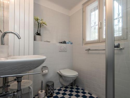 a white bathroom with a sink and a toilet at B&B villa sempreverde in Locarno