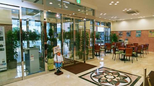 a restaurant with a statue in the middle of a building at Toyoko Inn Ueda Ekimae in Ueda