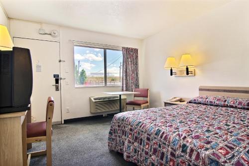 a hotel room with a bed and a window at Motel 6-Santa Rosa, NM in Santa Rosa