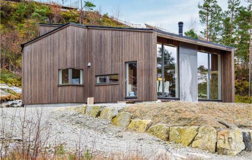 a wooden house on a hill with rocks at 3 Bedroom Amazing Home In Jørpeland in Jørpeland