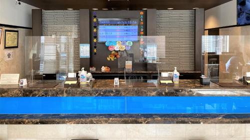 a lobby with a large counter with a blue pool at Toyoko Inn Kintetsu Yokkaichi eki Kita guchi in Yokkaichi
