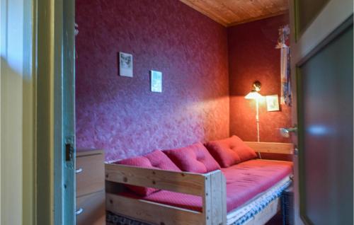 a room with a bed with pink walls at 3 Bedroom Lovely Home In Helvik in Egersund