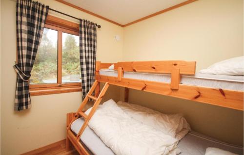 a bedroom with two bunk beds and a window at Beautiful Home In Nedstrand With House Sea View in Nedstrand