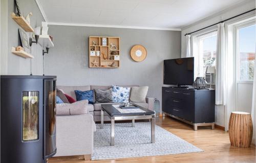a living room with a couch and a tv at Nice Home In Aksdal With House Sea View in Aksdal