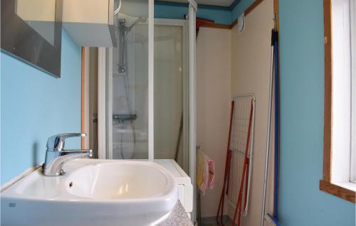 a bathroom with a sink and a shower at Beautiful Apartment In Sævelandsvik in Sæveland