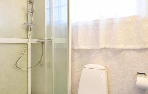 a bathroom with a shower with a toilet and a glass door at Amazing Home In Urangsvg With House A Panoramic View in Bømlo