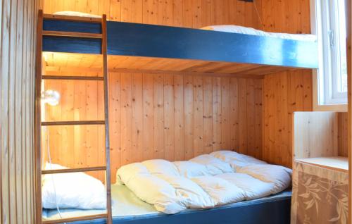 a bunk bed with a ladder in a room at Nice Home In Eikelandsosen With Sauna in Eikelandsosen