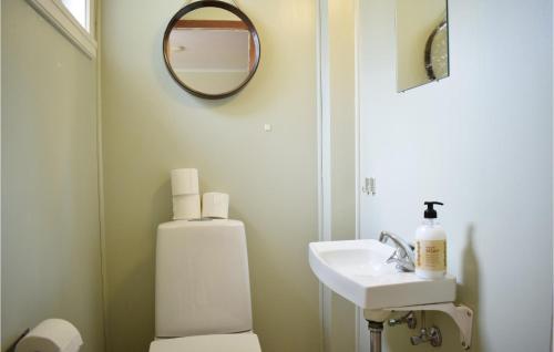 a bathroom with a toilet and a sink and a mirror at Awesome Home In Seim With 6 Bedrooms And Wifi in Seim