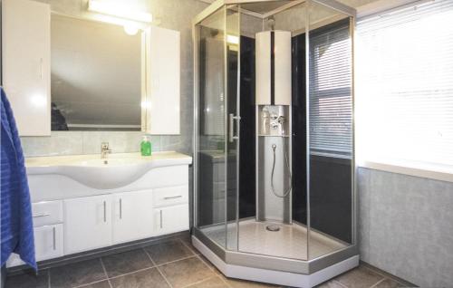 a bathroom with a shower and a sink at Cozy Home In Hatlestrand With Sauna in Hatlestrand
