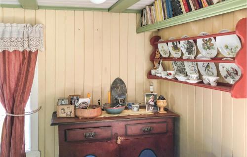 a room with a wooden cabinet with dishes on a wall at 1 Bedroom Cozy Home In Vinstra in Vinstra