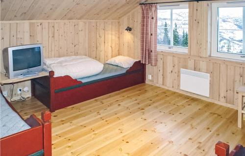 a room with a bed and a television in it at Skarsnuten in Hemsedal