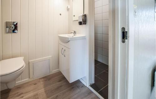 a bathroom with a white sink and a toilet at 2 Bedroom Lovely Home In Atna in Atnoset